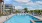pool area with reclining seats and landscaping