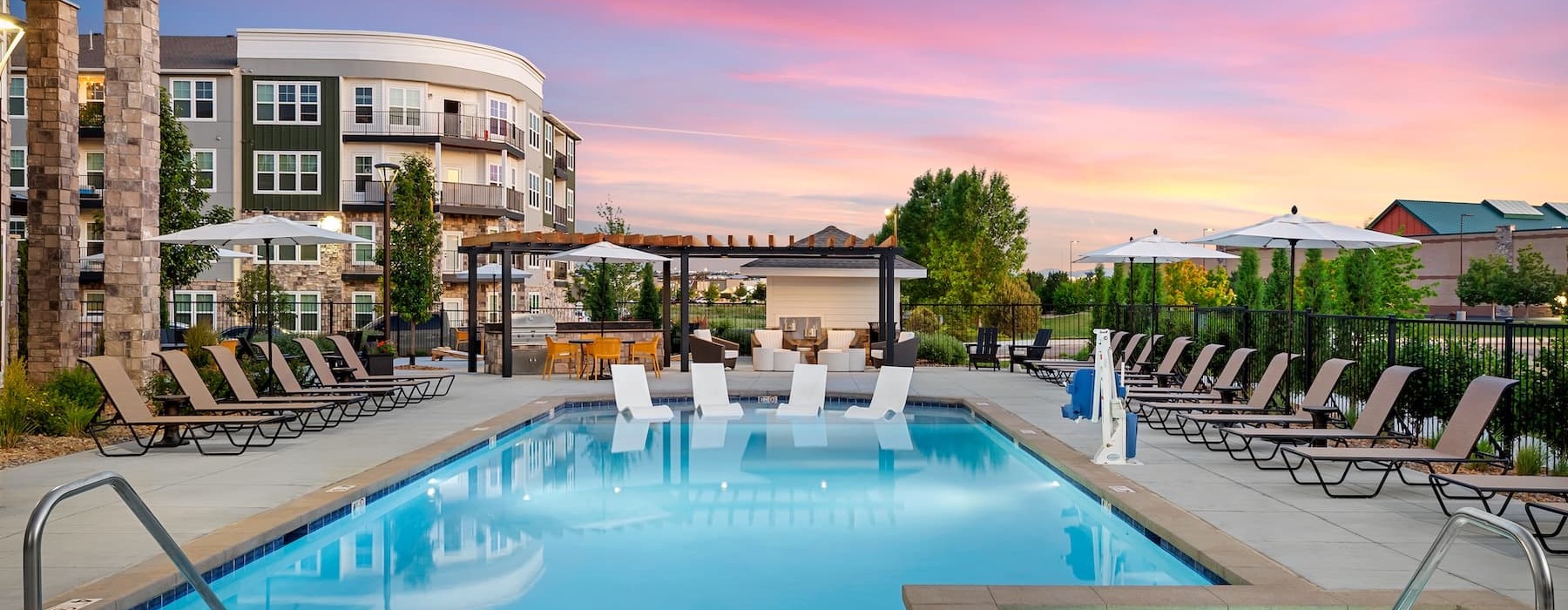 pool area with reclining seats and landscaping