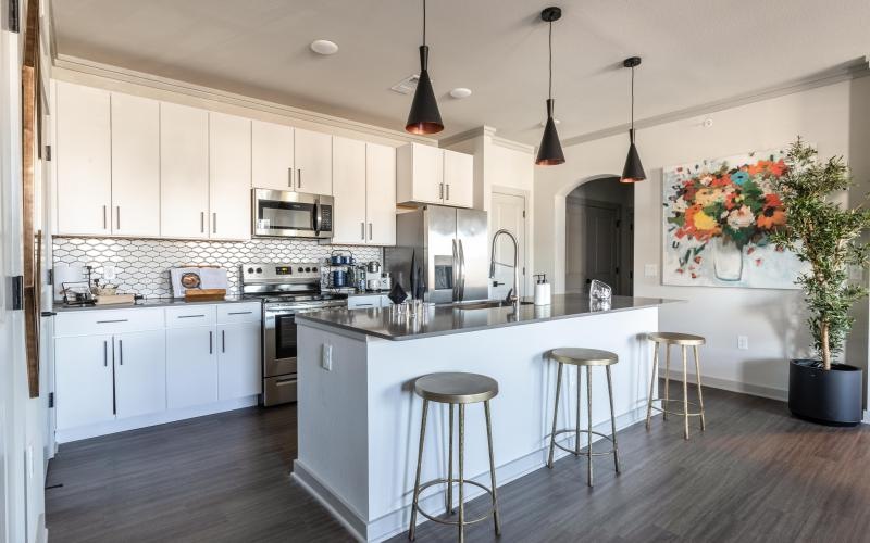 a kitchen with white cabinets