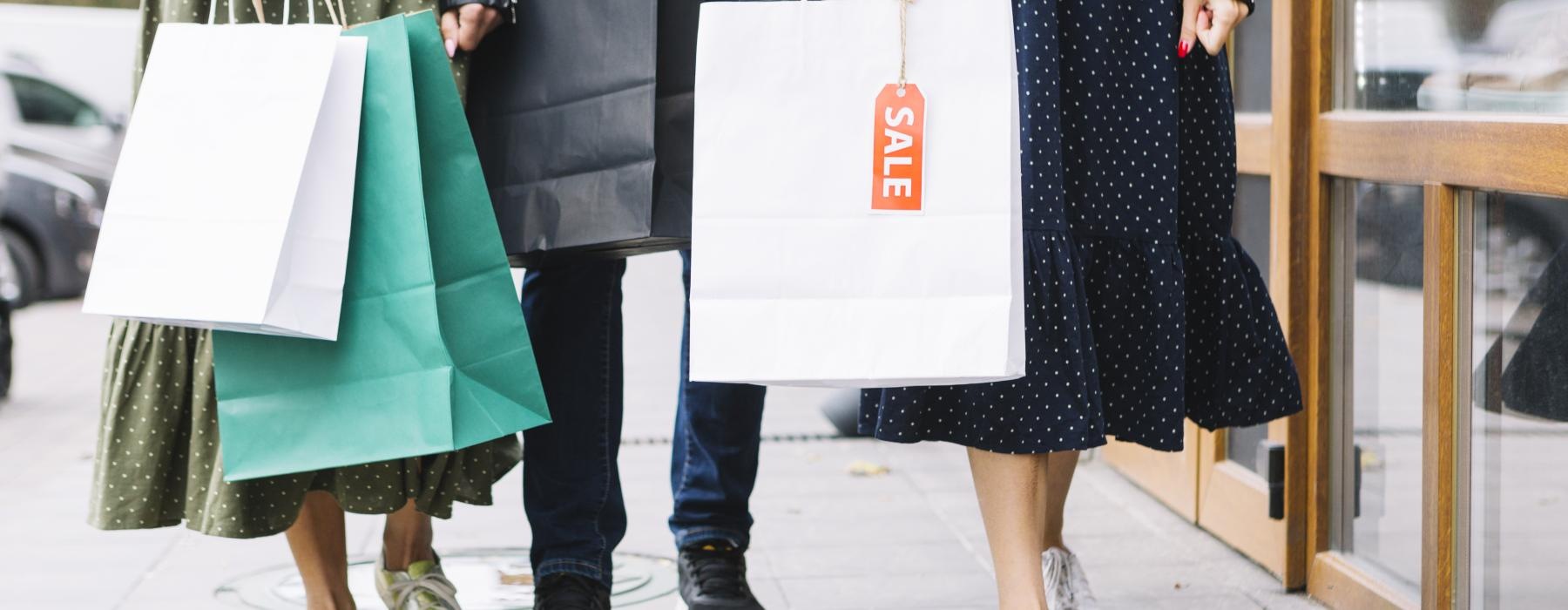 a group of women carrying shopping bags